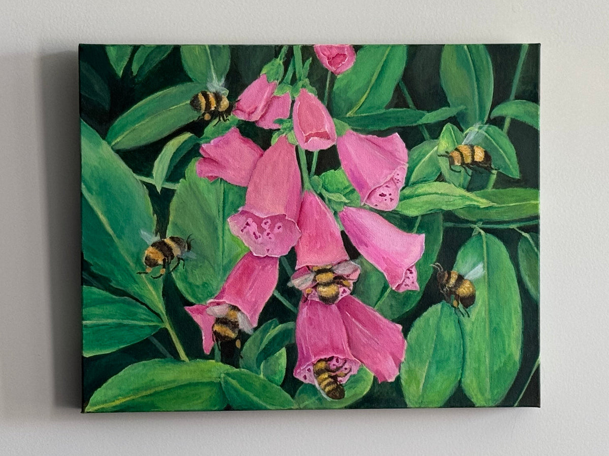 A zoomed out photo of a painting of pink foxglove flowers surrounded by green leaves and seven bees