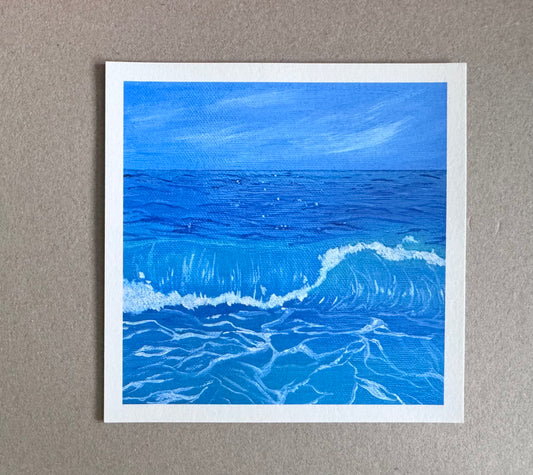 4.25in x 4.25in art print with white borders of a blue ocean with waves and a blue sky with cloud wisps