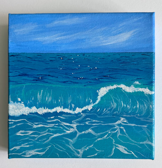 A square 6in x 6in canvas painting of a blue ocean with a breaking wave under a bright sky, shown against a plain light background