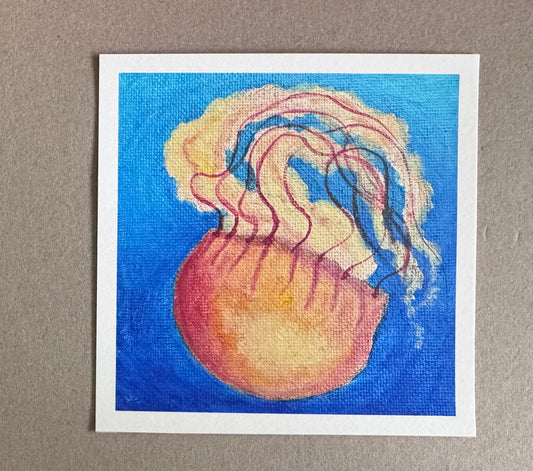 4.25in x 4.25in art print with white borders of an orange jellyfish floating upside down 